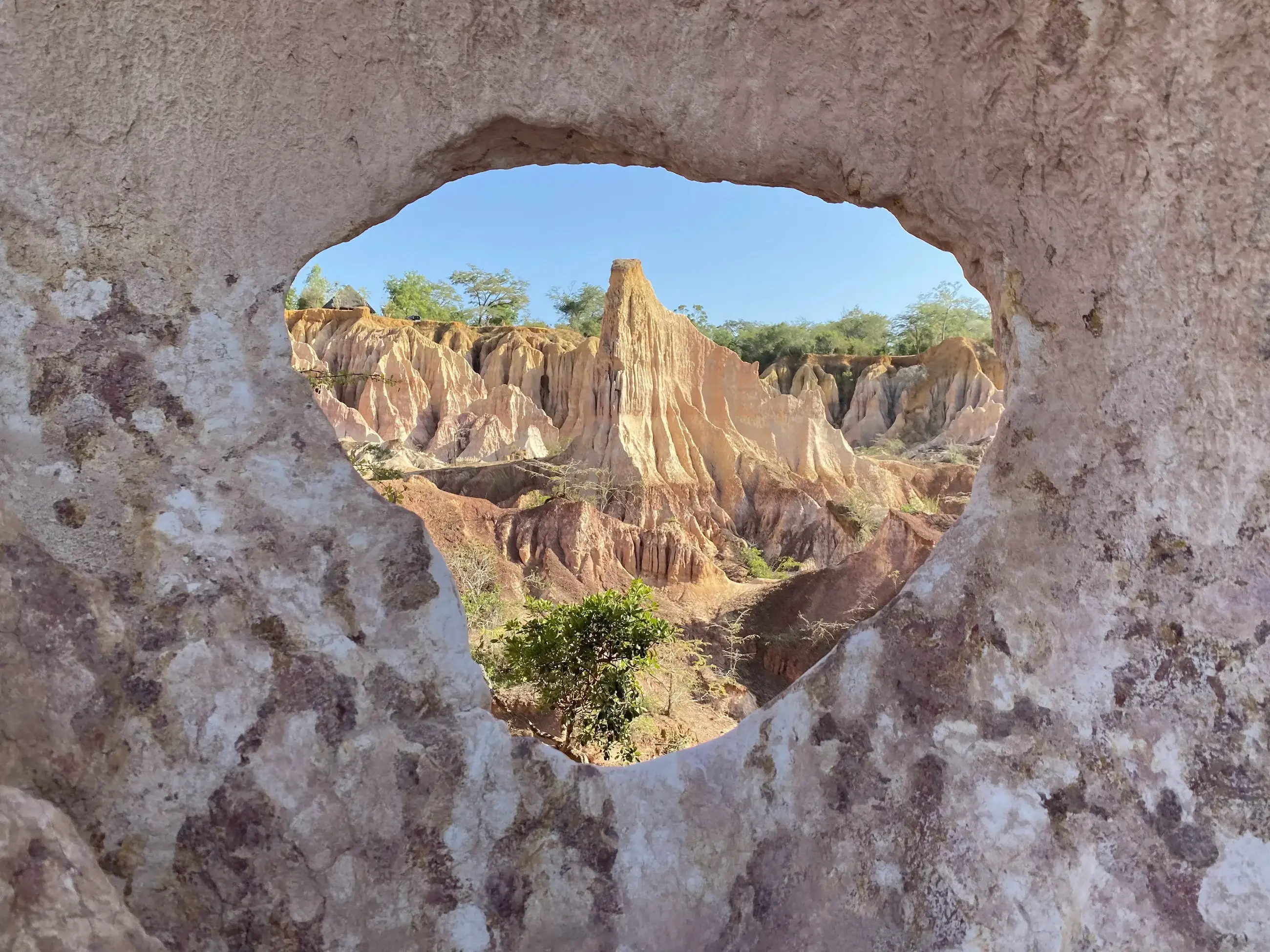 Eroded sandstone pinnacles framed by a natural rock arch